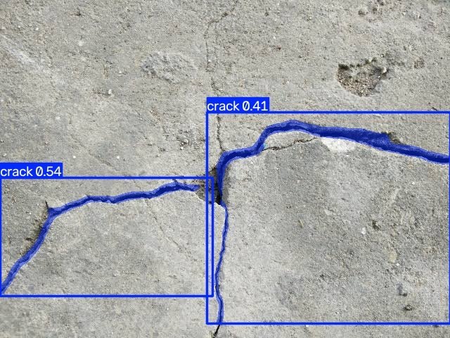 Broken concrete slab with the crack model's output: two cracks, top score 0.54